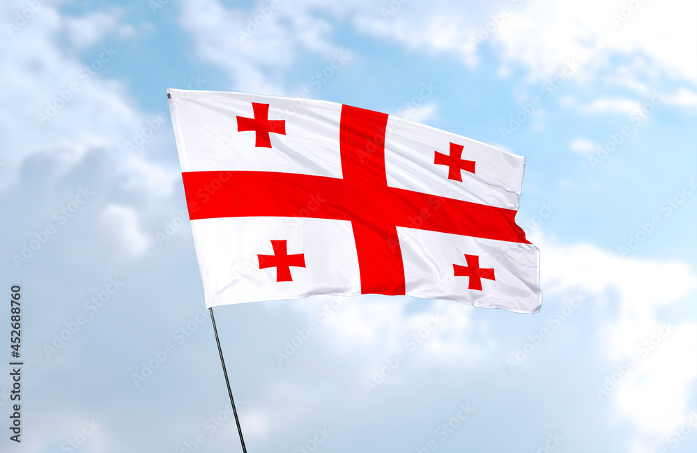 Flag of Georgia, realistic 3d rendering in front of blue sky