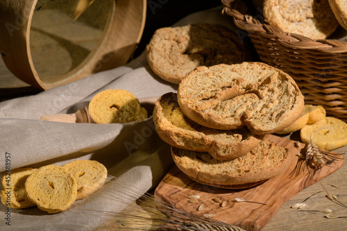 Italian appetizer Friselle. Apulian dried bread Friselle in wooden background photo