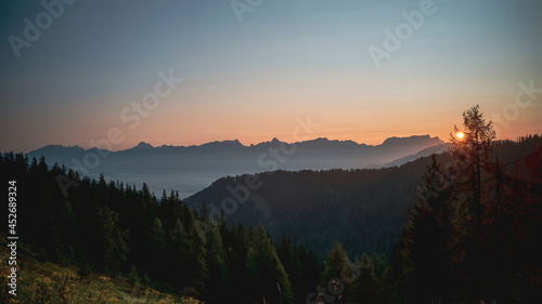a misty morning in the valley and beautiful sunrise on the mountains with view of the alps