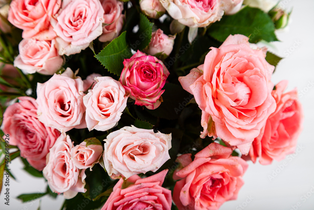 Bouquet of pink roses on a light wooden background. Bouquet of pink roses on a light wooden background.