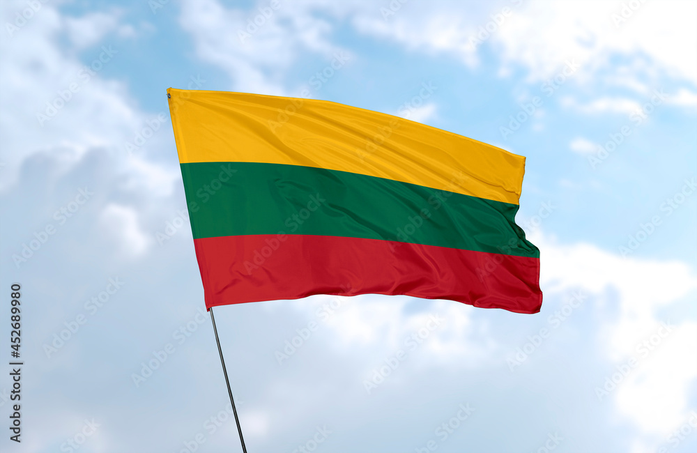 Flag of Lithuania, realistic 3d rendering in front of blue sky Flag of Lithuania, realistic 3d rendering in front of blue sky