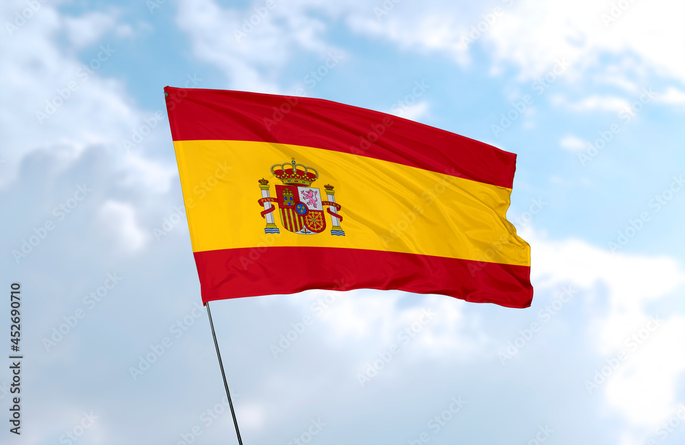 Flag of Spain, realistic 3d rendering in front of blue sky Flag of Spain, realistic 3d rendering in front of blue sky
