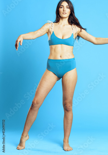 pretty woman in blue swimsuit attractive look Glamor fashion blue background