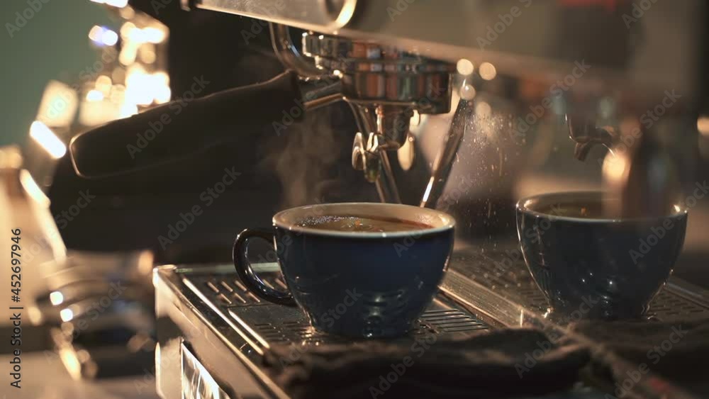 Coffee machine in cafe. Spbas Blue cup of delicious fresh beverage and falling down drop on metal rack of coffeemaker in cozy cafeteria macro Coffee machine in cafe. Spbas Blue cup of delicious fresh beverage and falling down drop on metal rack of coffeemaker in cozy cafeteria macro