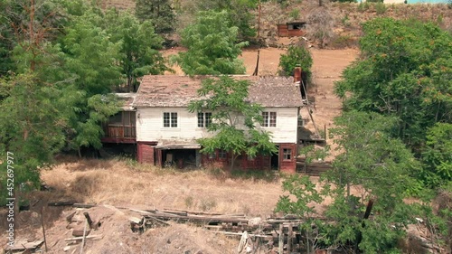 Aerial: Abandoned haunted house, Maupin, Oregon, USA photo