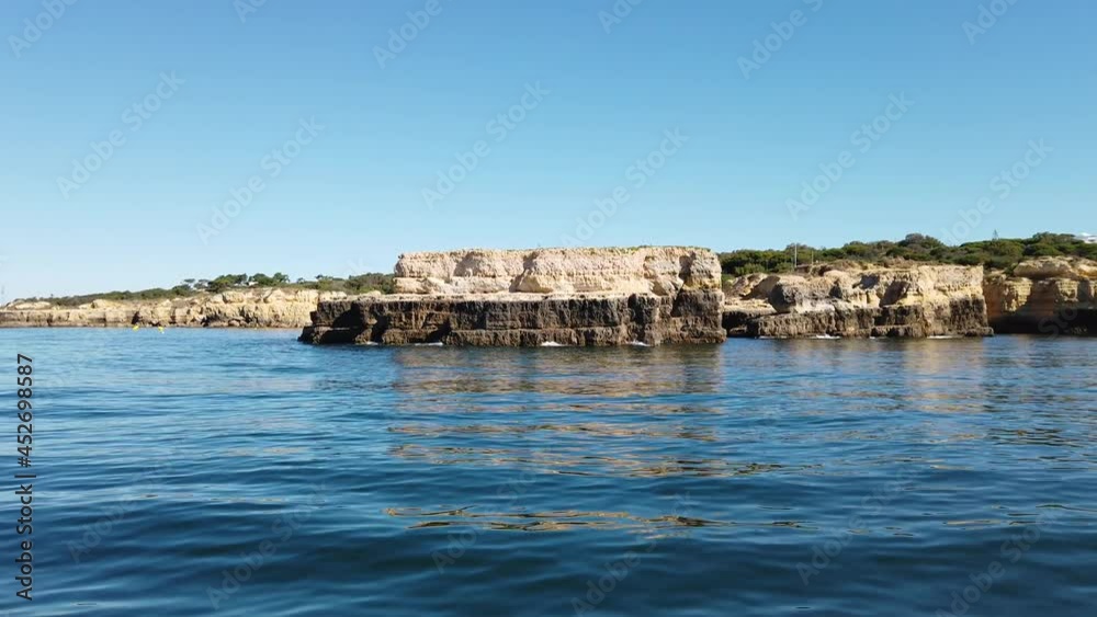 View of a rocky coastline from a boat shot with a stabilizer camera on the atlantic ocean.