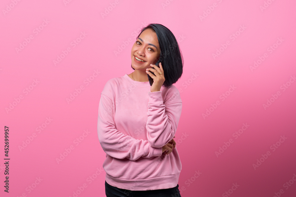 Asian woman shocked and surprised when receiving incoming call on smartphone