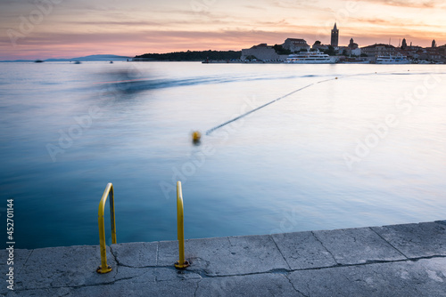 Fototapeta Naklejka Na Ścianę i Meble -  Old town of Rab with bay of Banjol in front and a bathing ladder