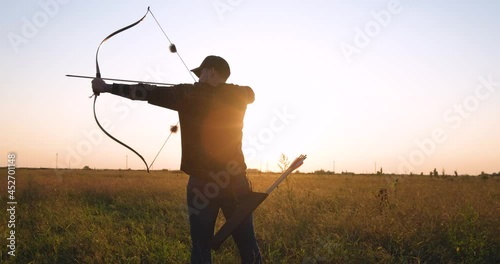 Man with bow outdoors in the field