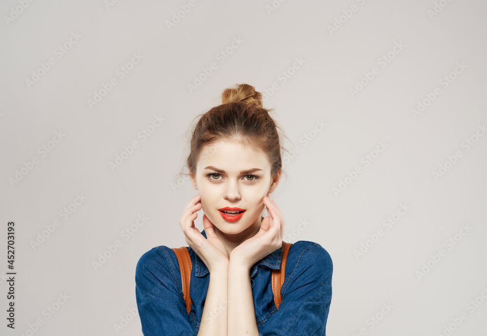 pretty young woman with backpack posing modern style