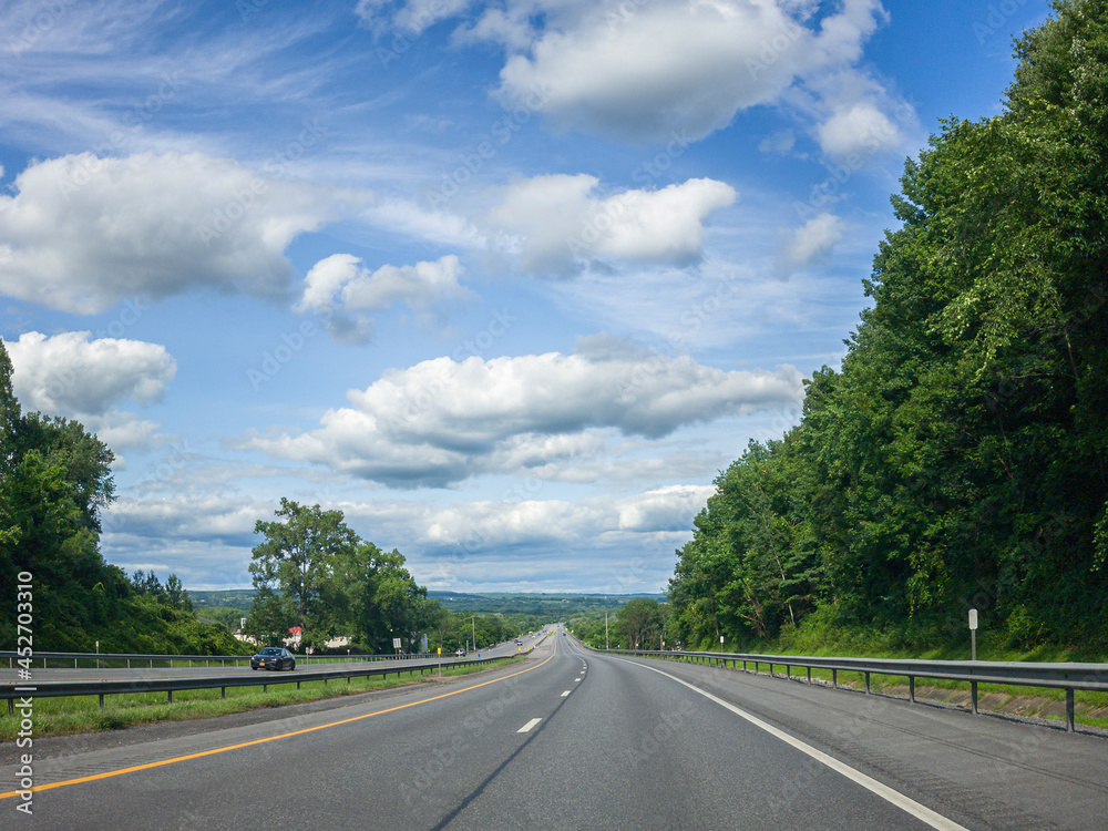 Classic Summer US Freeway View Going Downhill on a Cloudy Day in Upstate New York Classic Summer US Freeway View Going Downhill on a Cloudy Day in Upstate New York