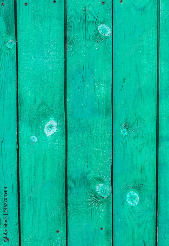 Fototapeta premium Green planks of the village fence. Vertical background