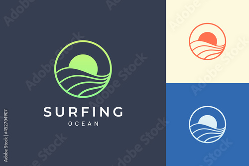 Fototapeta Sea or water theme logo with waves and sun in circle shape
