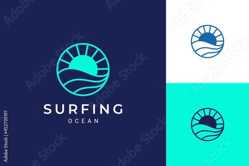 Ocean or water theme logo with waves and sun in circle