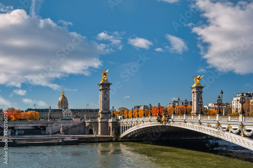 Paris France, city skyline at Seine River Pont Alexandre III bridge and Esplanade des Invalides with autumn foliage season © Noppasinw