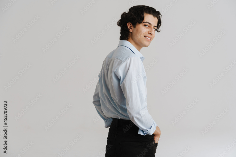 Smiling young brunette man in white smart shirt