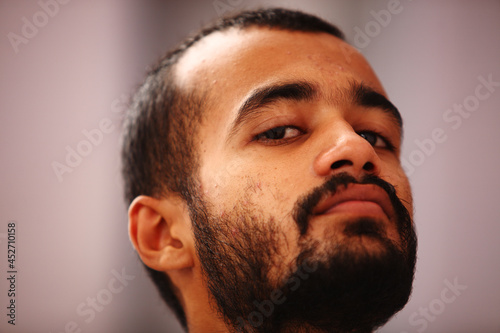 Fotografie Serious Muslim Bearded Young Adult Looking Down