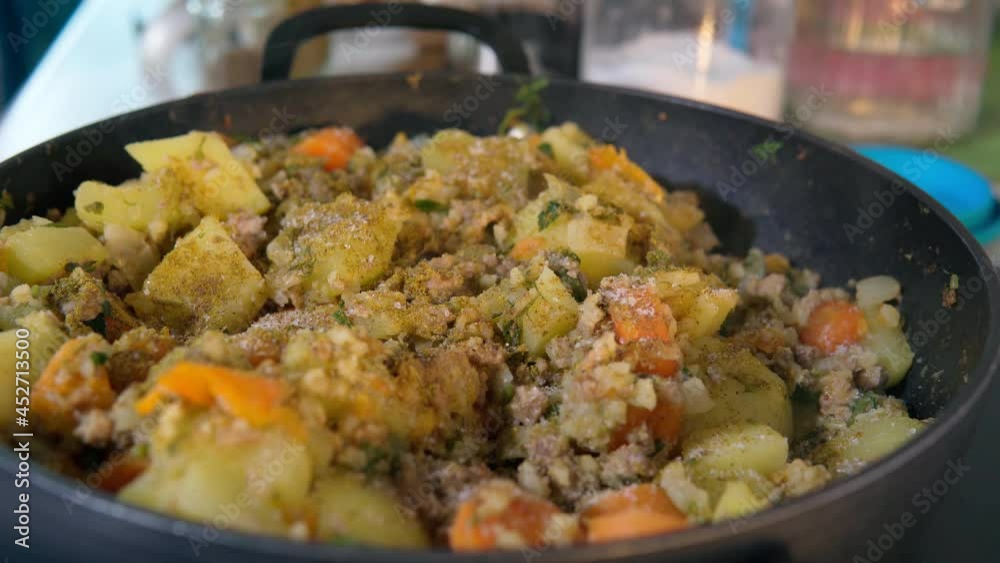 Pot with ingredients vegetable stew. Preparing vegetarian food. Adding salt. Pot with ingredients vegetable stew. Preparing vegetarian food. Adding salt.