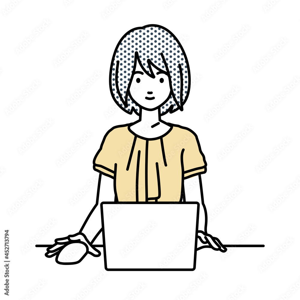 デスクで座ってPCを使っているオフィスカジュアルの女性 デスクで座ってPCを使っているオフィスカジュアルの女性