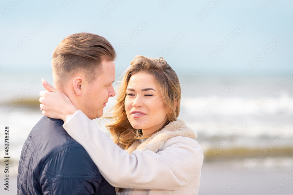 Two Young couple standing enjoying on a coast and enjoying each other.Summer,spring,autumn vacation.Closeup.