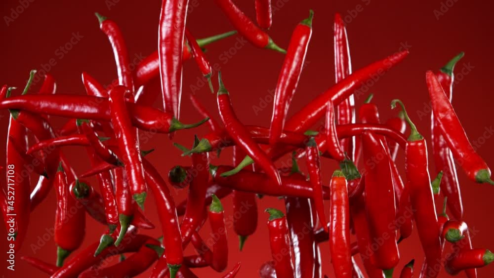 Super slow motion of flying red hot chilli peppers. Filmed on high speed cinema camera, 1000 fps