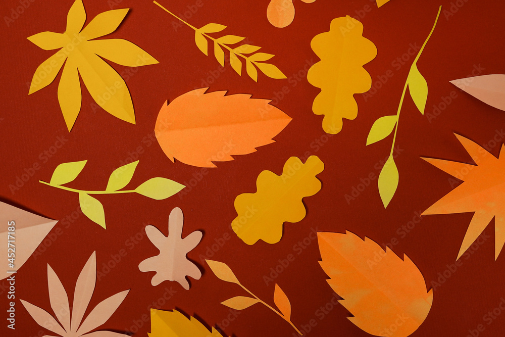 autumn paper leaves on red background, falling orange and yellow leaves wall