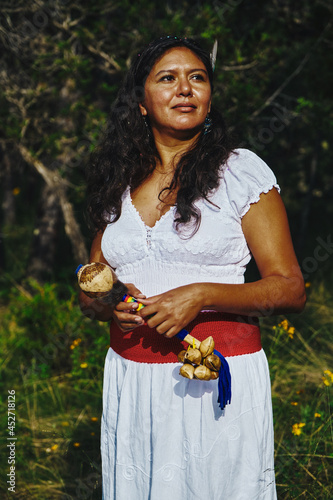 Woman Holding Indigenous Maracas With Ayoyotes photo