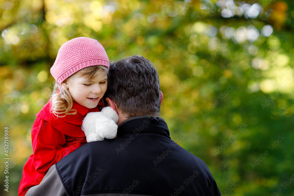 Happy young father having fun cute toddler daughter, family portrait together. Middle-aged Man with beautiful baby girl in autumn forest or park. Dad with little child outdoors, hugging. Love, bonding Happy young father having fun cute toddler daughter, family portrait together. Middle-aged Man with beautiful baby girl in autumn forest or park. Dad with little child outdoors, hugging. Love, bonding