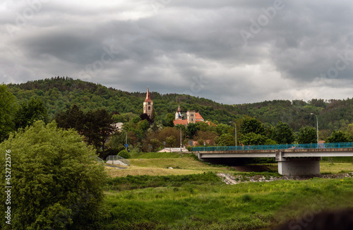 blue bridge over the river and the tower of the monastery