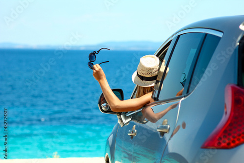 happy driver in car at sea in summer concept freedom and happy photo
