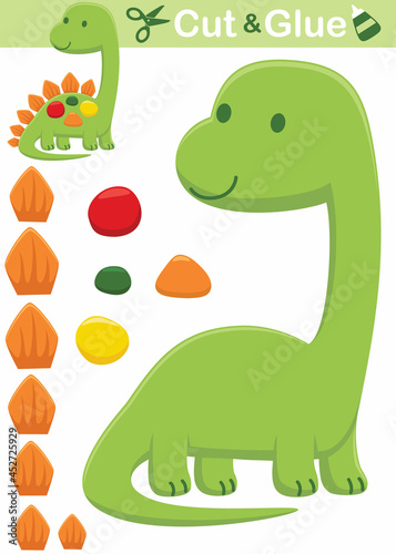 Funny green stegosaurus cartoon. Education paper game for children. Cutout and gluing