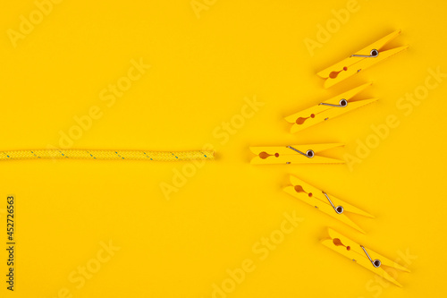 Yellow clothespins and rope. Lucky break concept. photo