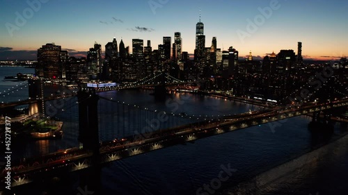 flying counterclockwise night view of downtown NYC and bridges