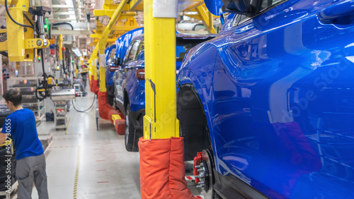Car Production line. Assembling cars at conveyor assembly line. Modern Assembly of cars at the plant. The automated build process of the car body. Industrial concept.