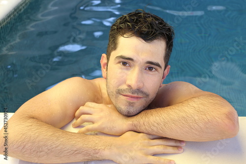 Young man relaxing in swimming pool © ajr_images