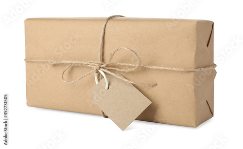 Parcel wrapped with kraft paper, twine and tag isolated on white