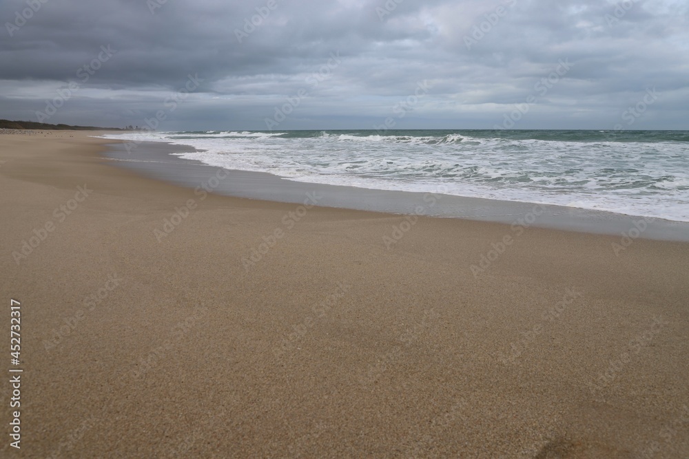 Sand and surf on an overcast day