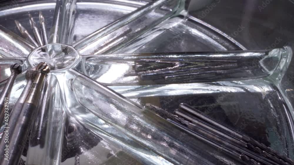 Close view of dental instruments on a transparent spinning platform. Modern dental clinic and dental tools Close view of dental instruments on a transparent spinning platform. Modern dental clinic and dental tools