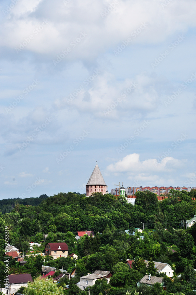 Panoramic views of residential buildings and a wooden church. Small wooden houses among green trees.