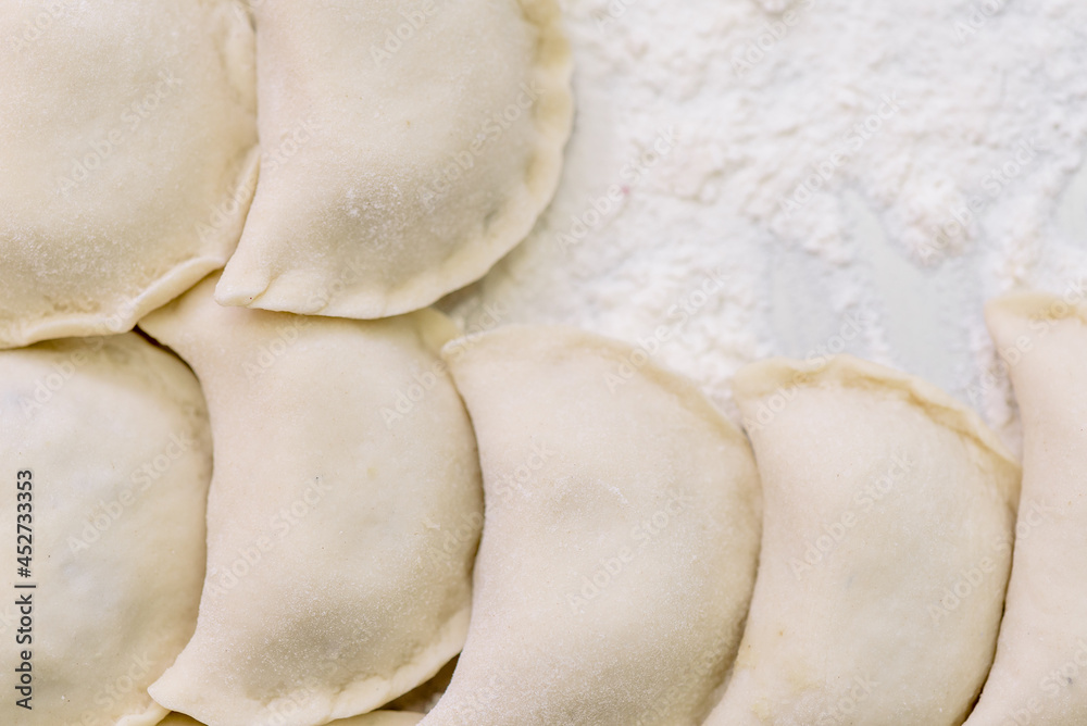Beautiful raw dumplings with variety of fillings. Dumplings production. Top view. High quality photo Beautiful raw dumplings with variety of fillings. Dumplings production. Top view. High quality photo