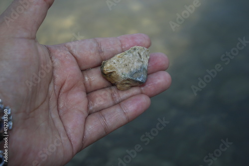a woman holding a rock from the lake on Turin.