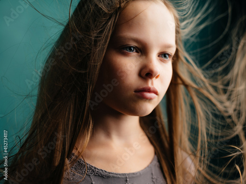 girl with closed eyes and loose hair close up isolated background
