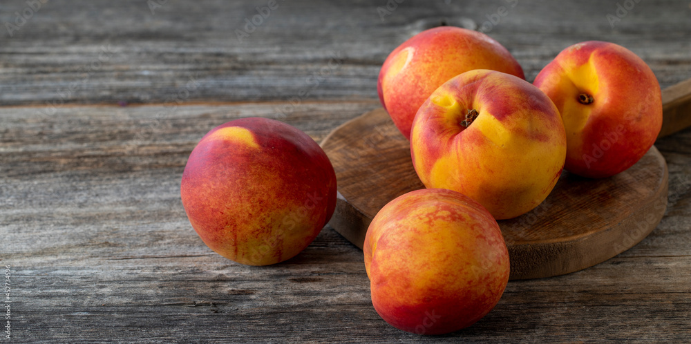 Vivid peaches and nectarines on wood background. Copy space Vivid peaches and nectarines on wood background. Copy space