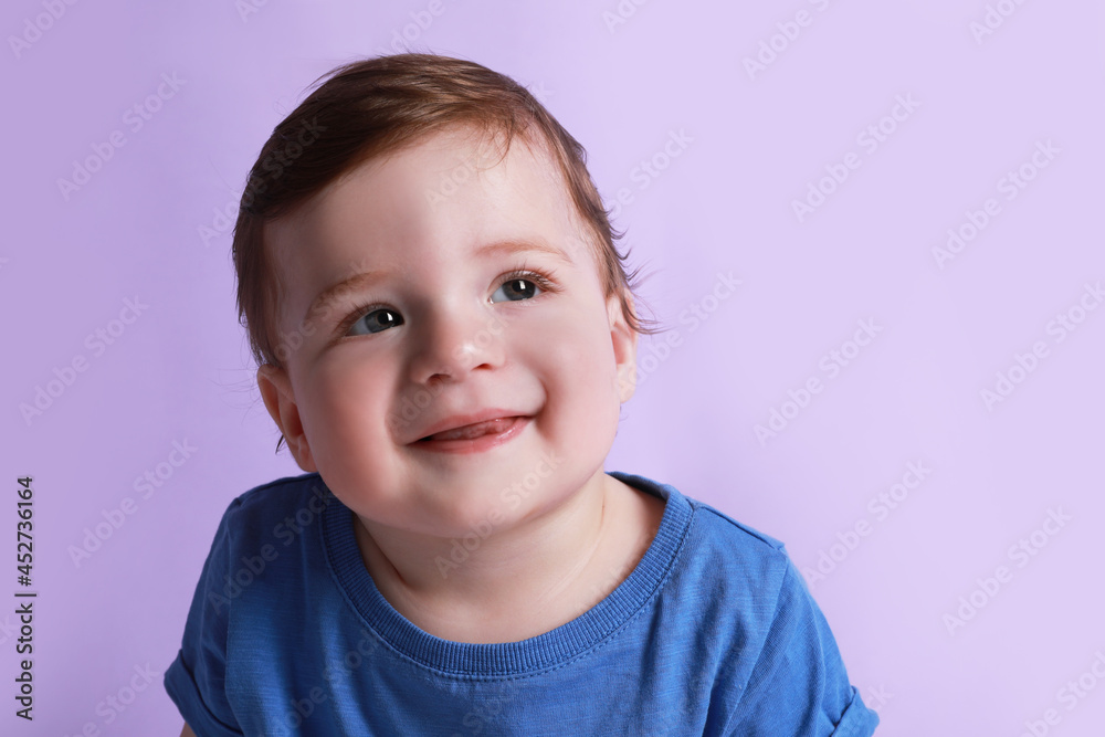 Cute happy baby boy on violet background Cute happy baby boy on violet background