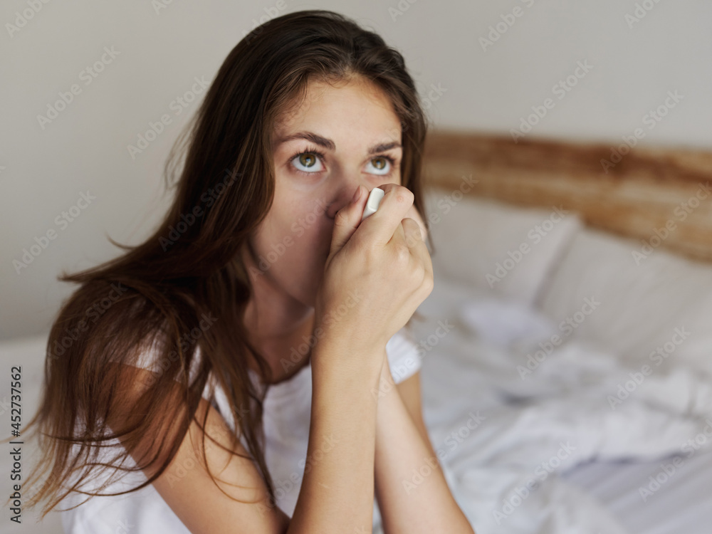 woman holding a thermometer in her mouth waiting for the temperature result woman holding a thermometer in her mouth waiting for the temperature result