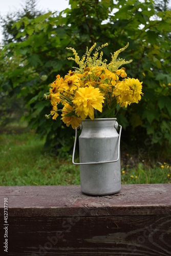 yellow flowers in a watering can