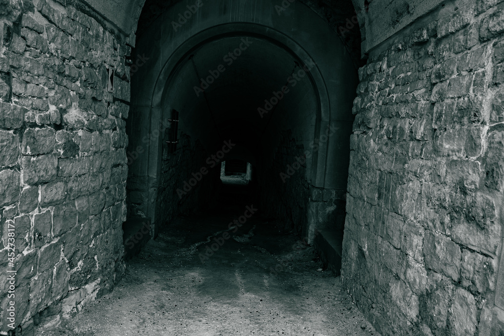a corridor in the dark of an ancient fortress