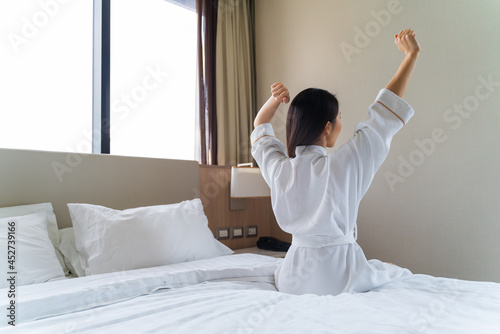 Asian woman Wake up in the Morning, Stretching on the Bed and get up in bedroom