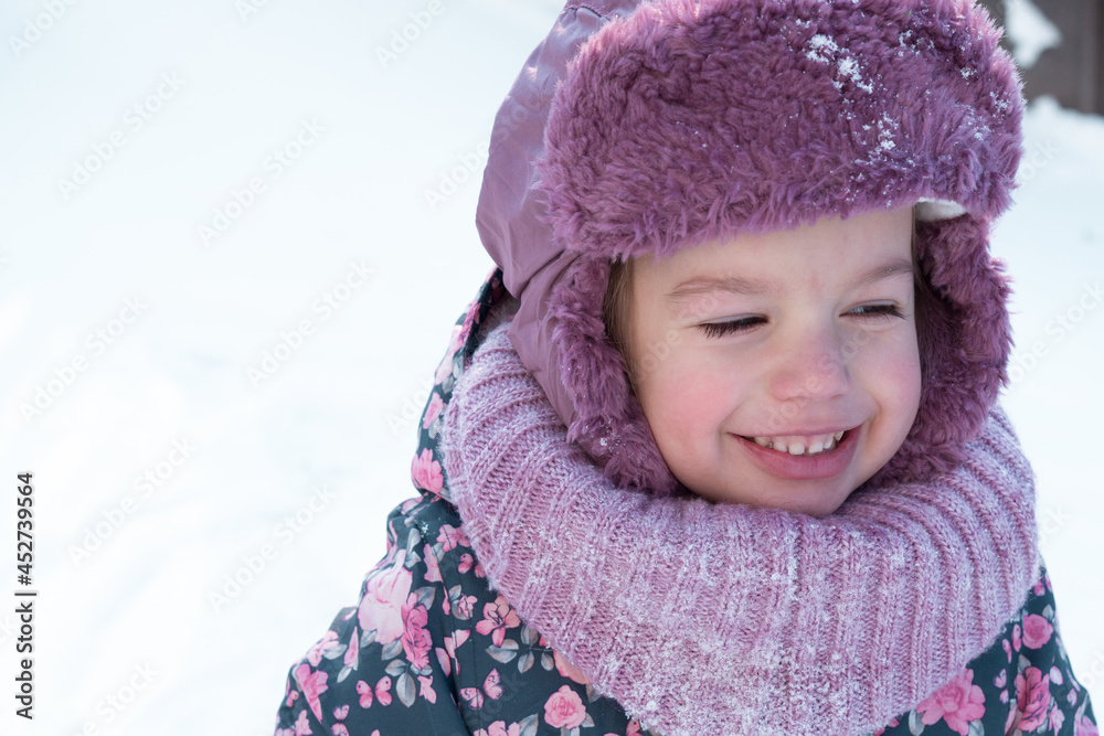 Winter, family, childhood concepts - close-up portrait authentic little preschool minor 3-4 years girl in pink hat look at camera posing smile in snowy frosty weather. happy kid face have fun outdoors Winter, family, childhood concepts - close-up portrait authentic little preschool minor 3-4 years girl in pink hat look at camera posing smile in snowy frosty weather. happy kid face have fun outdoors