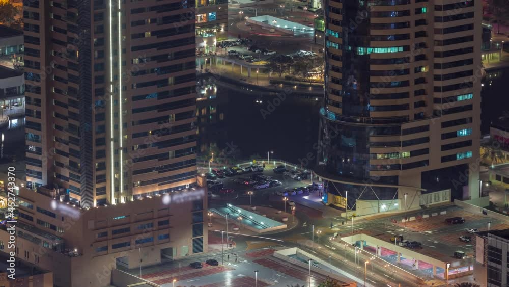 Car parking for light vehicles night timelapse in Dubai luxury residential district, aerial view from above.